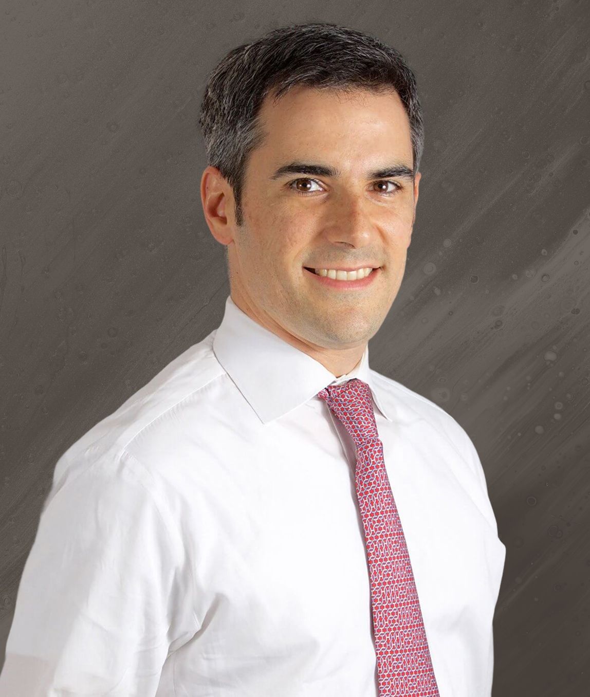 Man in a white shirt and pink tie.