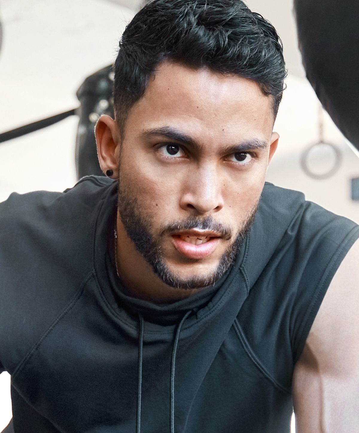 Focused man training in gym environment.