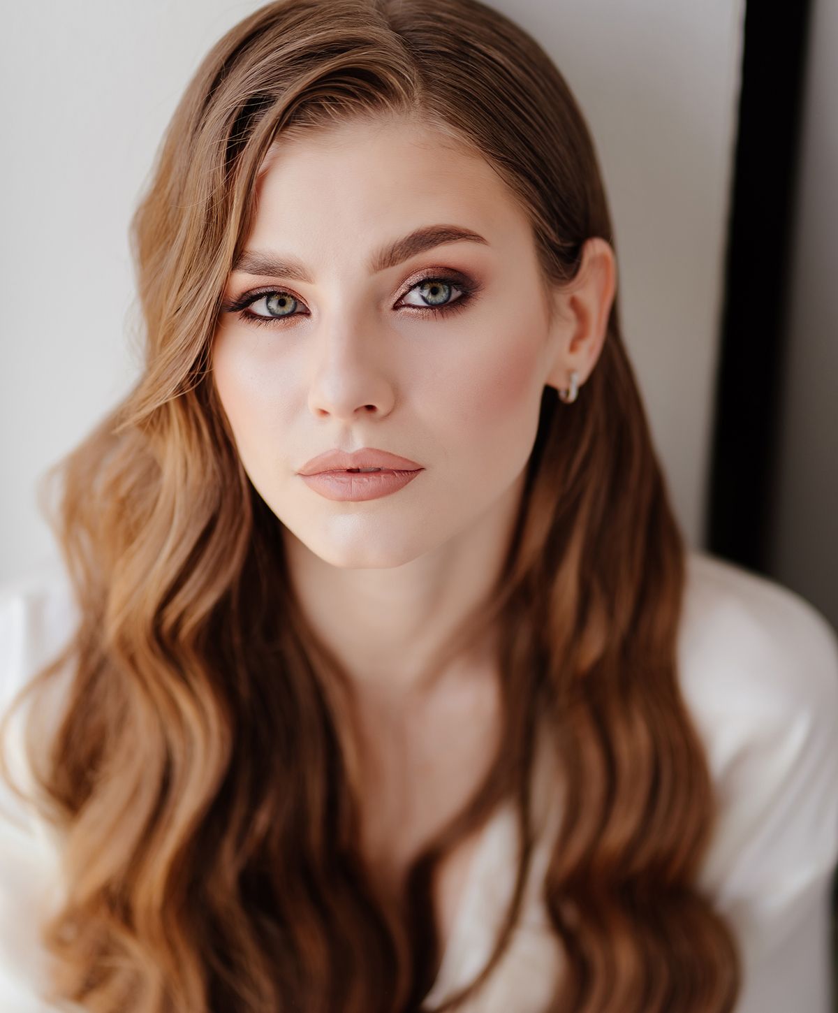 Man with muscular physique posing against white backdrop